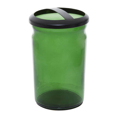 Green glass jar with black lid on a white background