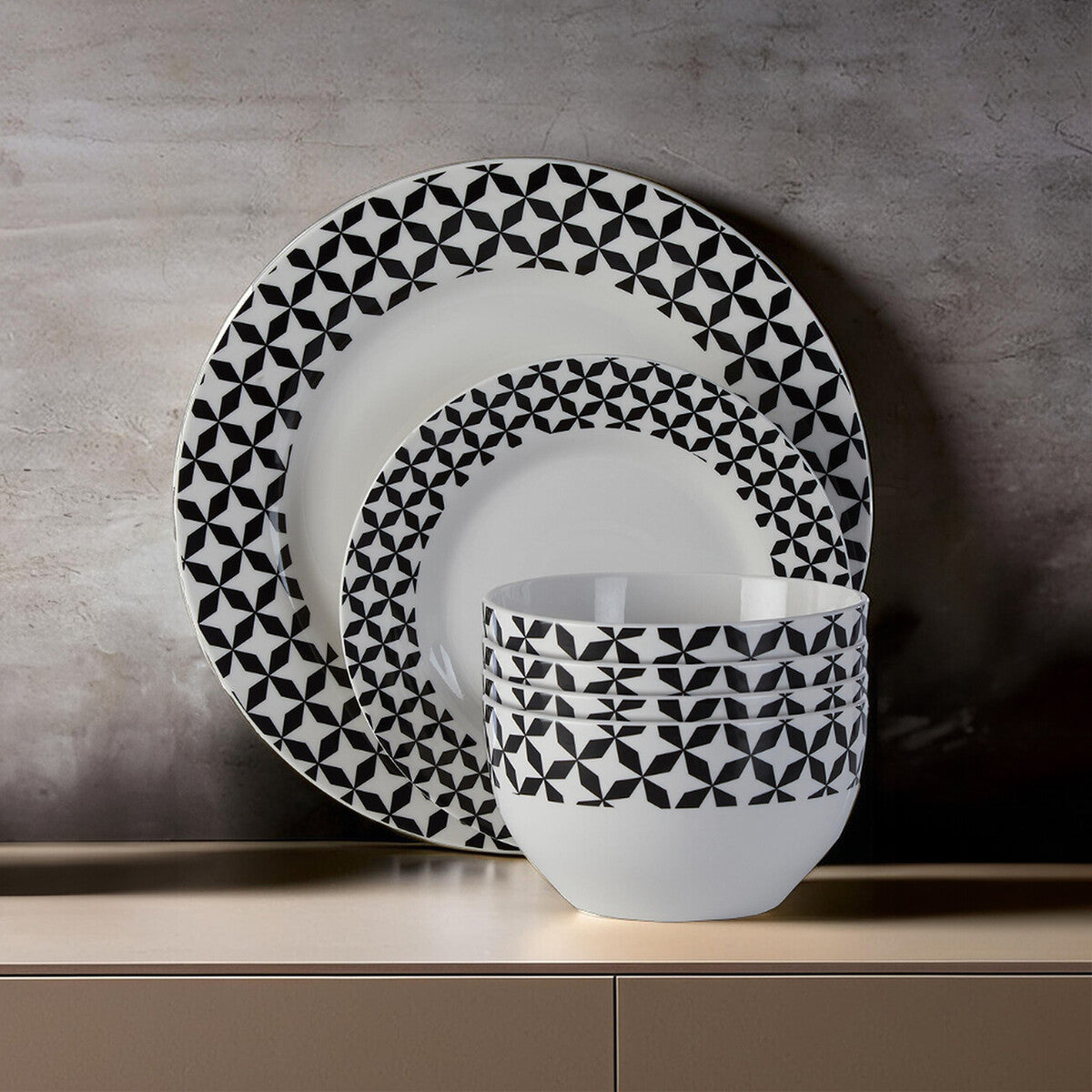 Ceramic dinnerware set with black geometric pattern on a neutral background