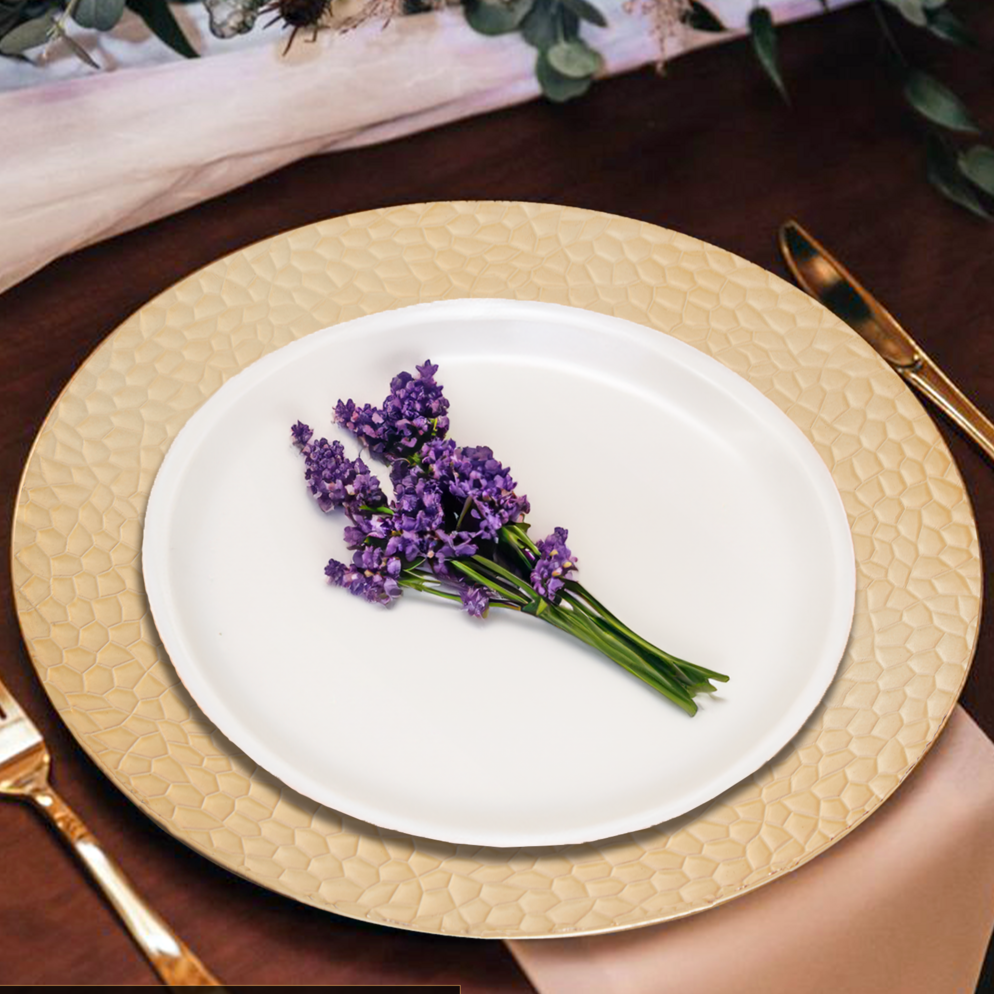 White plate with lavender on a gold-rimmed charger, set on a wooden table.
