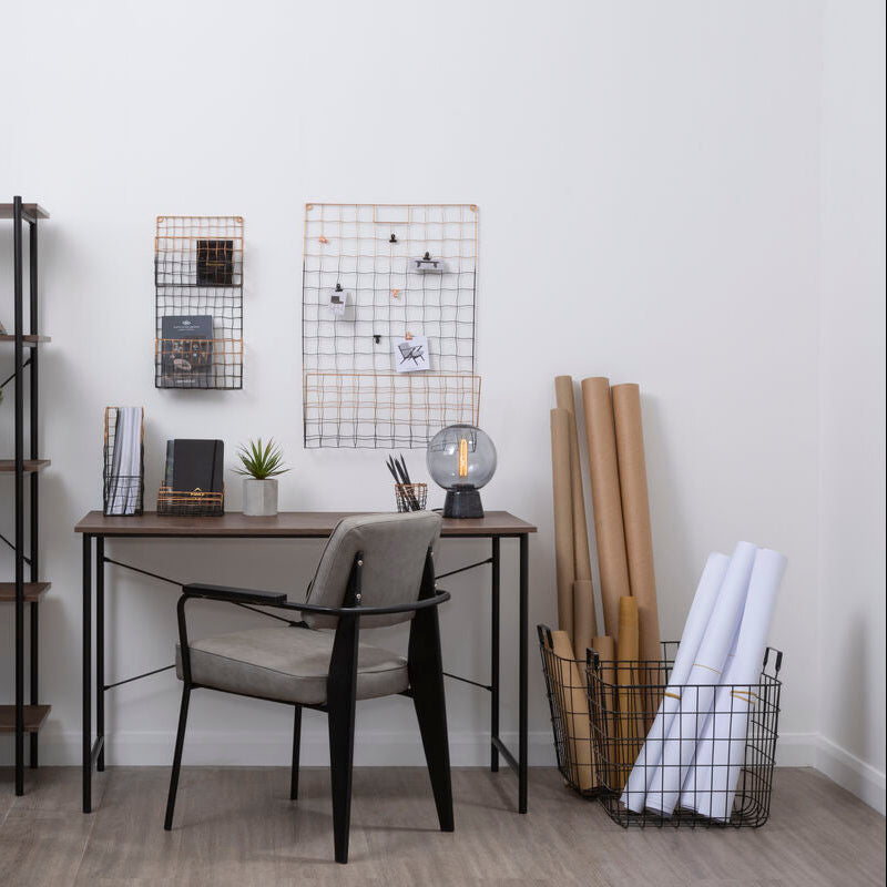 Modern home office with a desk, chair, bookshelf, and decorative items.