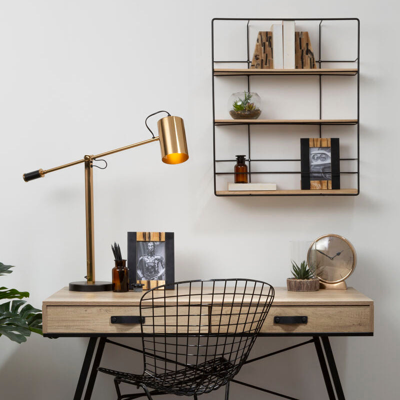 Modern home office with a desk, chair, lamp, and shelves.