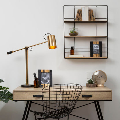 Modern home office with a desk, chair, lamp, and shelves.