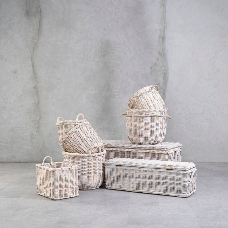 Set of wicker baskets of various sizes on a gray surface with a gray background