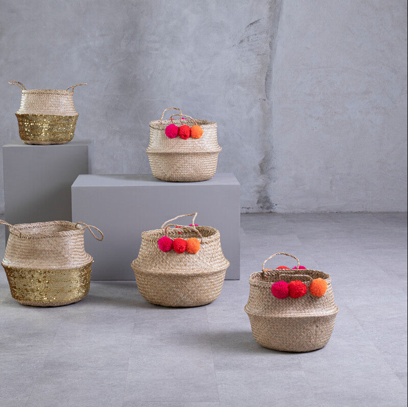 Set of woven baskets with decorative items on a gray background