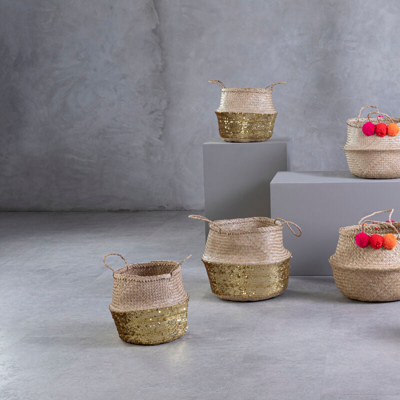 Set of woven baskets with fruits on a gray concrete floor and background