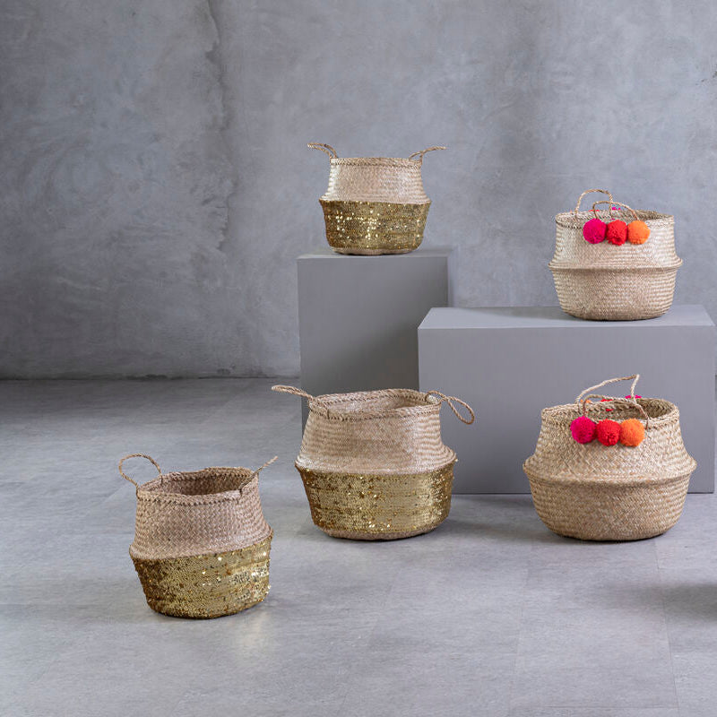 Set of woven baskets with fruits on a gray concrete floor and background